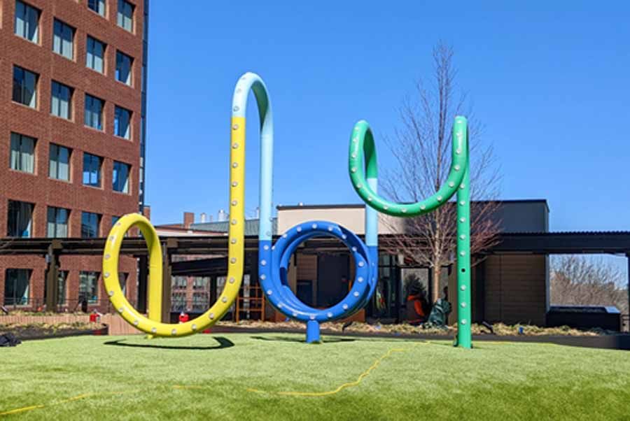 "Find Joy" Curved Steel Artwork Brings Joyful Color to New Rooftop Garden at the Kendell Center in Cambridge